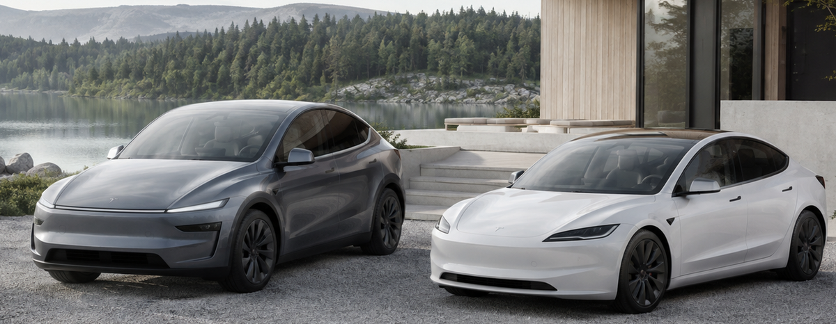 Two Tesla Model Y cars, one in metallic gray and one in white, parked side-by-side on a gravel driveway in front of a modern house with a lake and forest in the background.